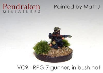 RPG-7 gunner in bush hat, kneeling